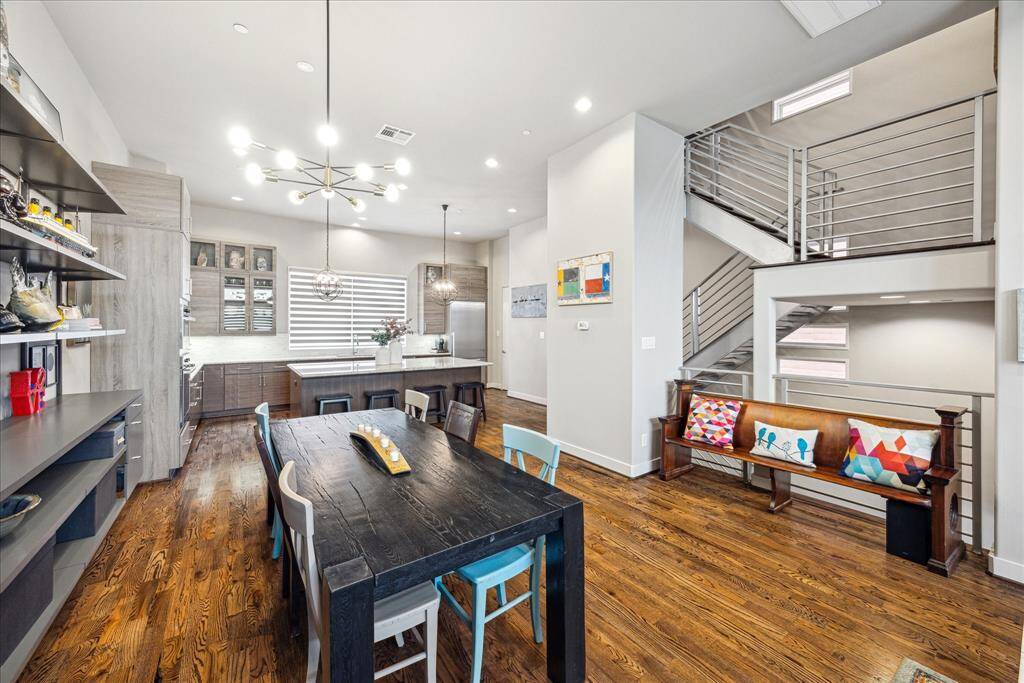 This open-concept space features an expansive, modern kitchen outfitted with premium Miele appliances and a state-of-the-art Miele refrigerator that conveys with the home. Ample cabinetry and contemporary lighting complement the stylish dining area, creating a space that’s as functional as it is beautiful.