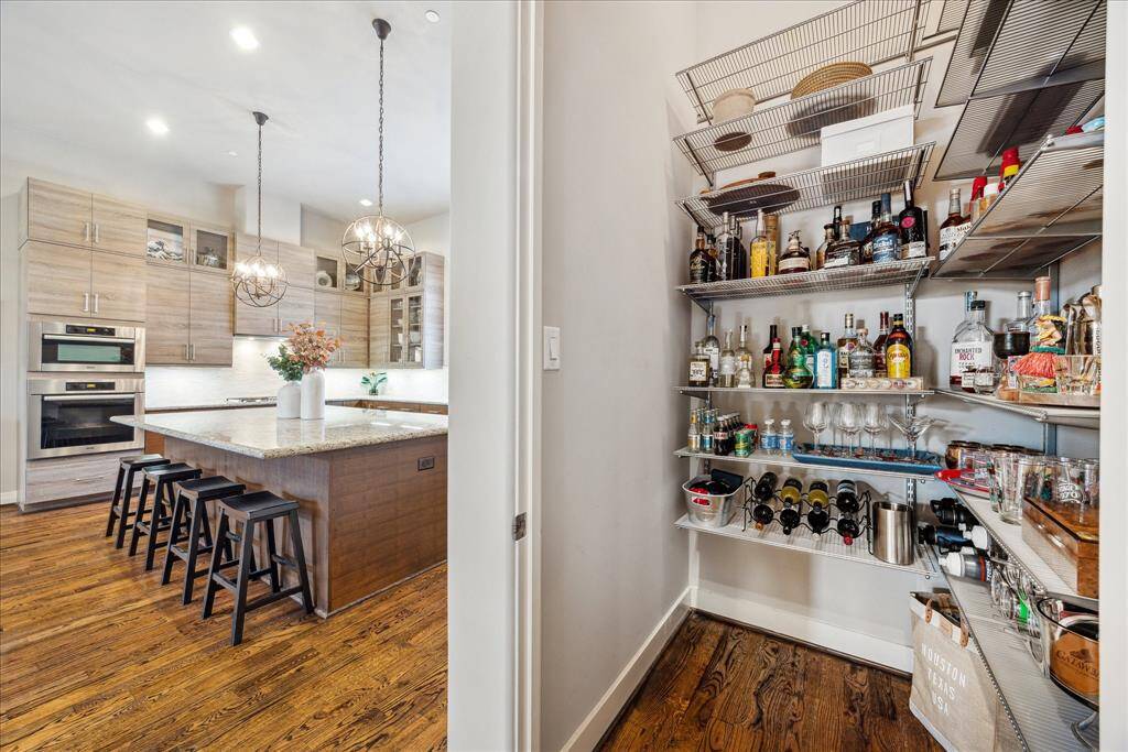 Just off the kitchen, this neatly organized storage space adds everyday convenience - perfect as a second pantry or a refined bar area for displaying glassware and bottles. With a dedicated room like this on each of the home’s four levels, these versatile spaces are thoughtfully designed with future living in mind, featuring the structural framework for seamless conversion into a private elevator and blending luxury with long-term flexibility.