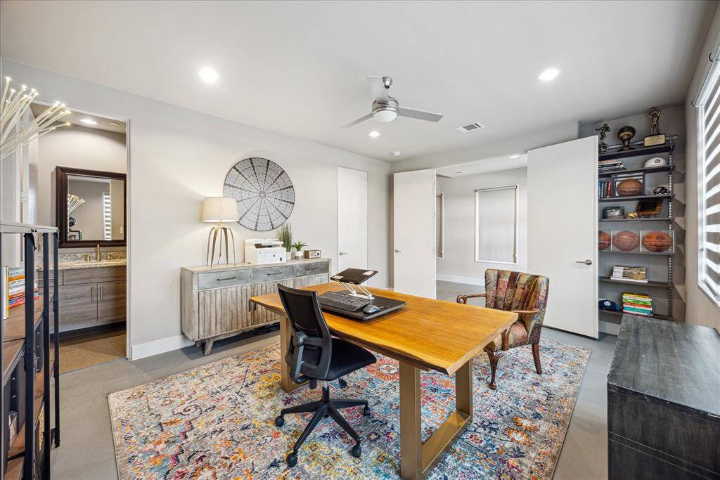 Bright and versatile, this modern space offers ample natural light and built-in shelving, ideal as a stylish home office or easily converted into a comfortable bedroom with en suite bath.