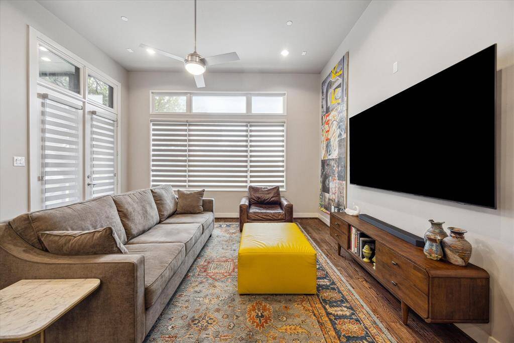 Soaring ceilings and walls of natural light define this stunning living room, designed for both relaxation and style. With expansive seating, sleek built-ins, and an airy, modern vibe, this is the perfect space to unwind or entertain in the heart of the home.