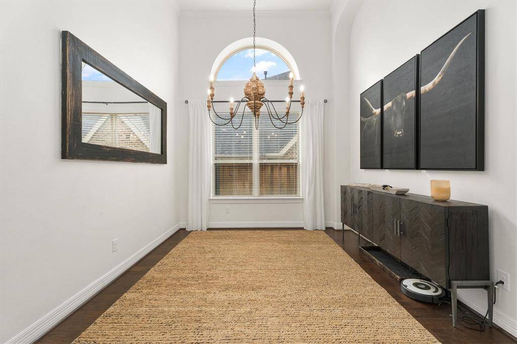 Just off the entry, you'll discover a bright and open formal dining room, ideal for entertaining. The space is beautifully illuminated by a stunning chandelier, adding a touch of elegance. With ample room for hosting family gatherings or dinner parties, this area is perfect for creating lasting memories.