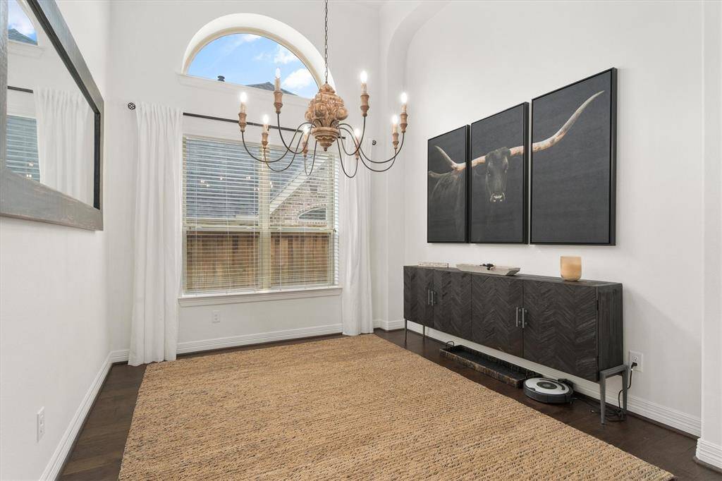 Just off the entry, you'll discover a bright and open formal dining room, ideal for entertaining. The space is beautifully illuminated by a stunning chandelier, adding a touch of elegance. With ample room for hosting family gatherings or dinner parties, this area is perfect for creating lasting memories.