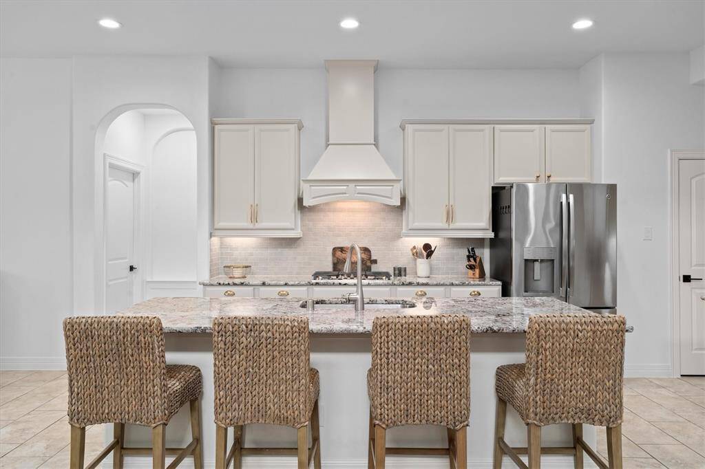 Beautifully designed, the open-concept kitchen seamlessly flows into the family room – perfect for hosting and everyday gatherings. Updated with modern appliances, freshly painted cabinets, and sleek new hardware, this space effortlessly blends style and functionality. Generous counter space makes meal prep a breeze, while the open layout keeps you connected to the heart of the home.