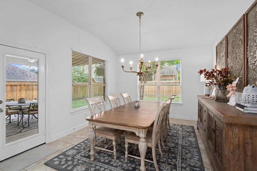 Just off the kitchen, the expansive breakfast room offers an impressive amount of space – perfect for casual dining or morning coffee. The room is beautifully accented by a statement chandelier, adding a touch of elegance to this bright and welcoming area.