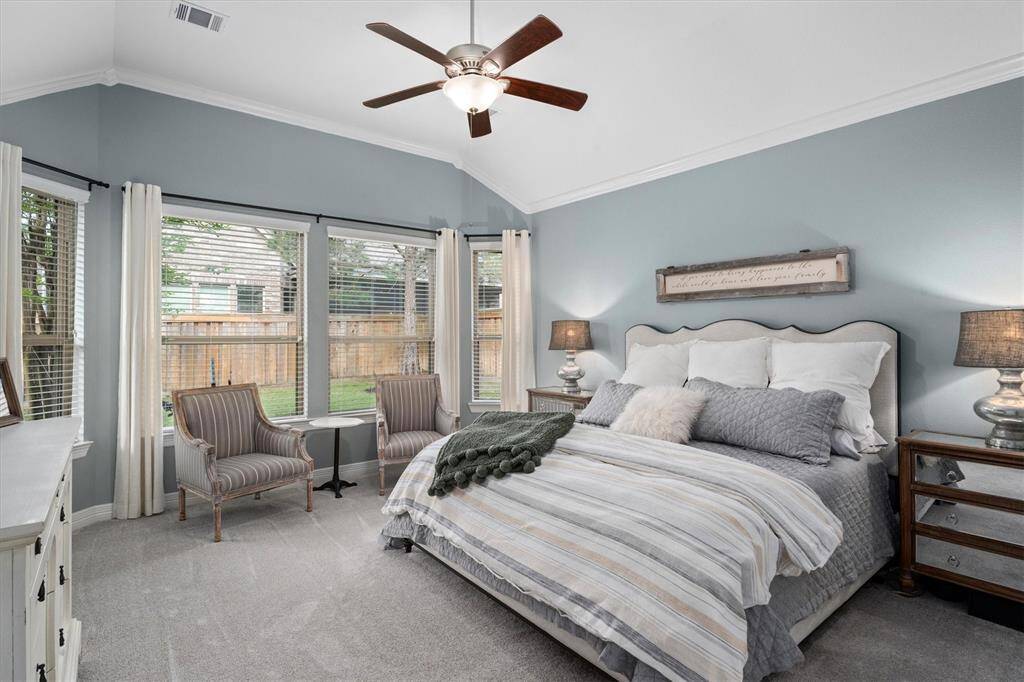 The spacious primary suite is a true retreat, featuring large windows that overlook the lush, green backyard, filling the room with natural light. With ample space for a cozy sitting area, this luxurious bedroom combines comfort and elegance, offering a private haven to unwind.