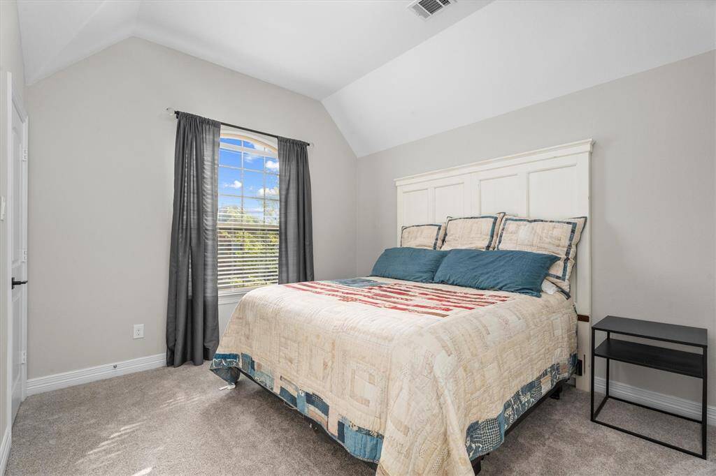 Upstairs, one of the secondary bedrooms offers a comfortable and private retreat, complete with its own full bathroom. Ideal for guests or family members seeking a bit of privacy, this well-appointed space ensures convenience and comfort.