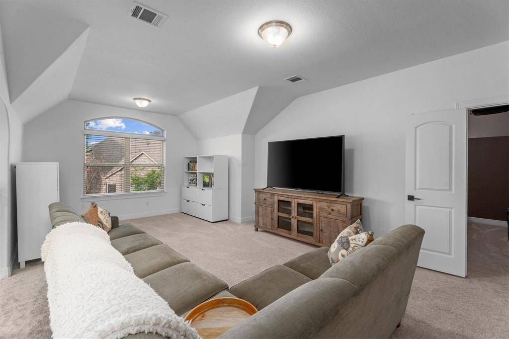 The expansive game room offers a fantastic space for entertainment and relaxation, overlooking the family room for an open and connected feel. With direct access to the adjacent media room, this versatile area is perfect for game nights, movie marathons, or simply unwinding.