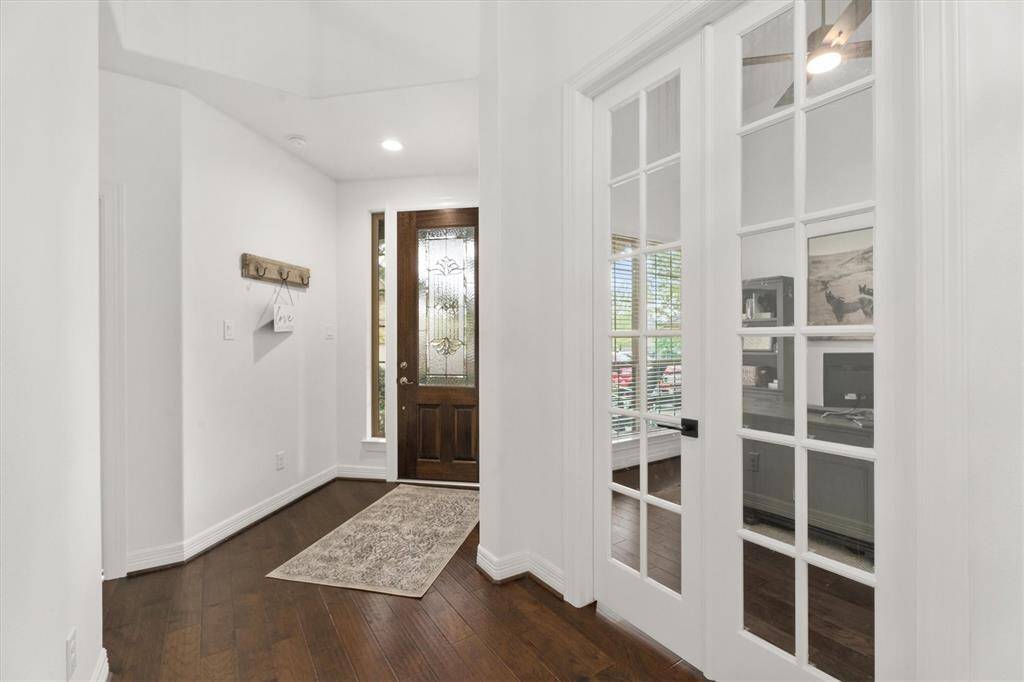 Just off the entry, this bright and airy office features soaring ceilings, beautiful French doors, and plenty of natural light. The perfect space for productivity, creativity, or a quiet retreat!