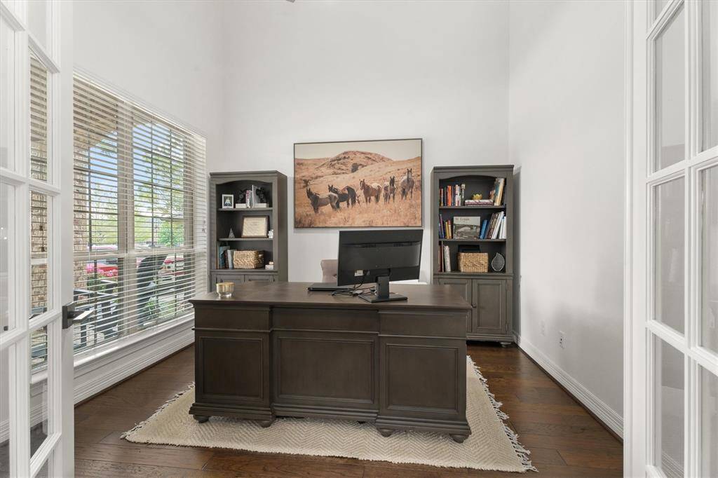 Just off the entry, this bright and airy office features soaring ceilings, beautiful French doors, and plenty of natural light. The perfect space for productivity, creativity, or a quiet retreat!