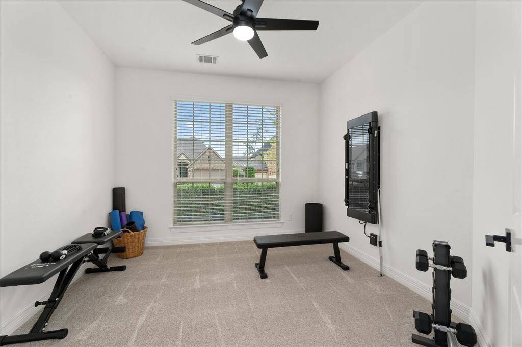 Located just across from the office, this spacious secondary bedroom is currently being used as a workout room. With endless possibilities, this space can easily transform into a guest room, playroom, or whatever suits your needs!