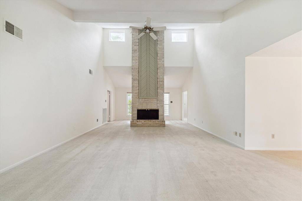 A soaring ceiling and clerestory windows enhance the grandeur of this spacious family room, anchored by a dramatic floor-to-ceiling brick fireplace. There’s room to spread out, relax, and make the space truly your own.