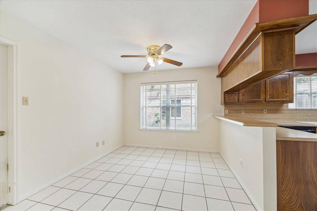 Enjoy casual meals with your favorite people in this charming breakfast area featuring tile flooring, ample space for your table, and great natural light to start the day right.
