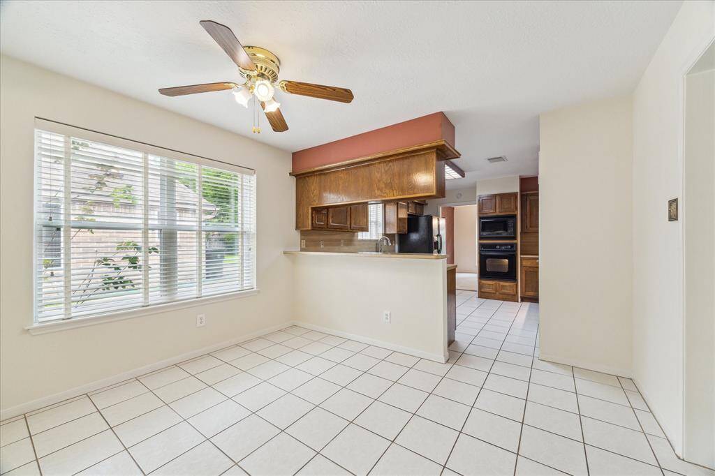 Start your day with cornflakes and coffee in this cheerful breakfast nook, where natural light pours in and tile flooring adds a clean, classic touch.