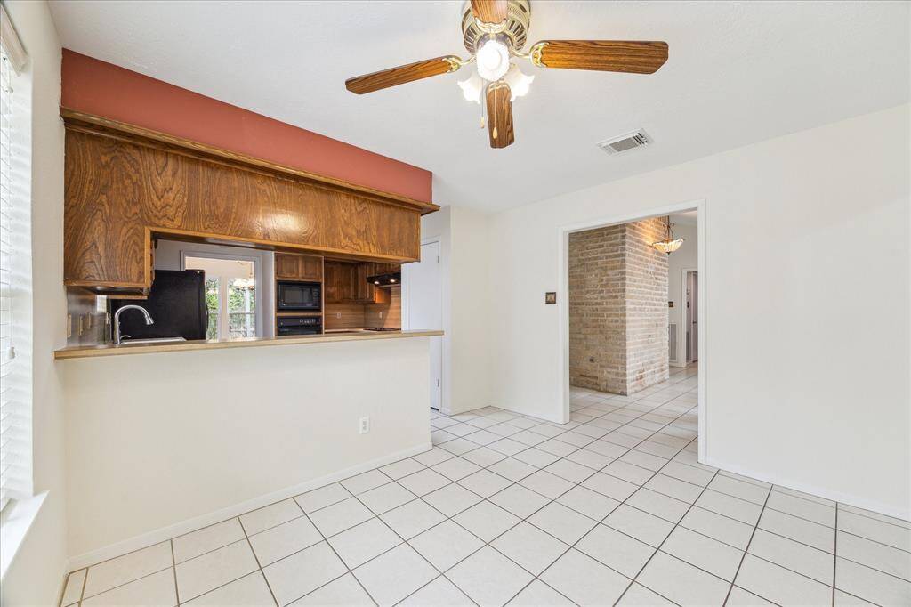 The kitchen is separated from the breakfast area by a raised bar. This is a great spot to grab a quick meal, serve snacks and drinks to guests, or add bar stools to create additional seating.