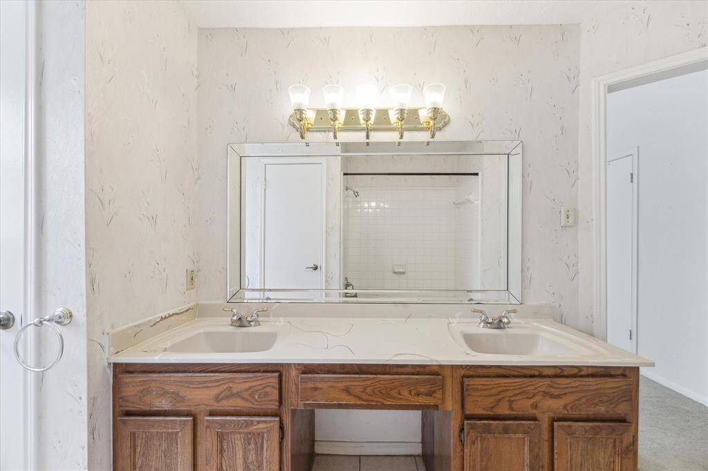 The owner's ensuite bathroom will be easy to share with a dual sink vanity with ample storage below, knee space to sit while you primp, and a beveled mirror with vanity lights above.