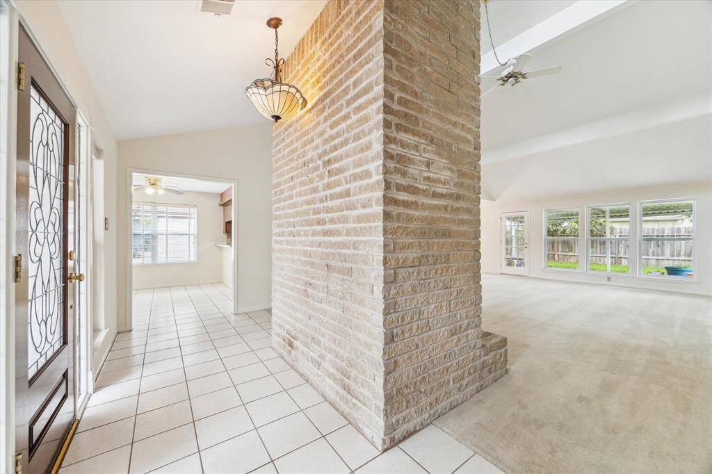 Natural light, high ceilings, and that amazing brick fireplace make one unforgettable first impression the moment you walk in. It’s the kind of space that instantly feels warm, open, and ready to welcome you home.
