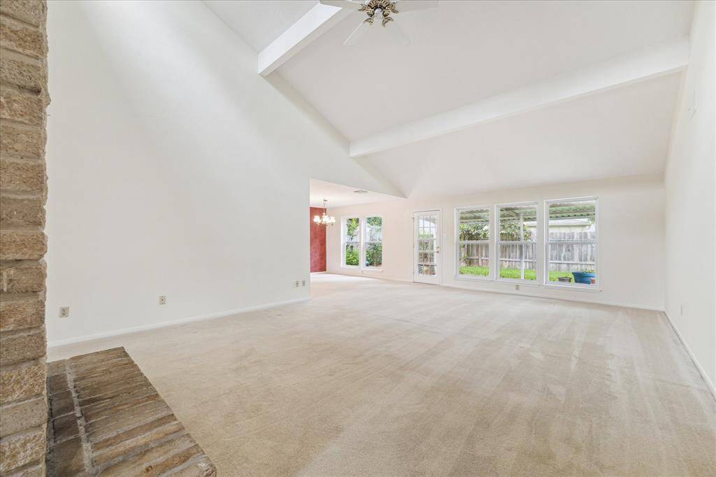 Soaring ceilings, a wall of windows, and a glass door to the backyard fill this spacious family room with natural light. It’s an inviting space that’s perfect for everyday living or easy entertaining.