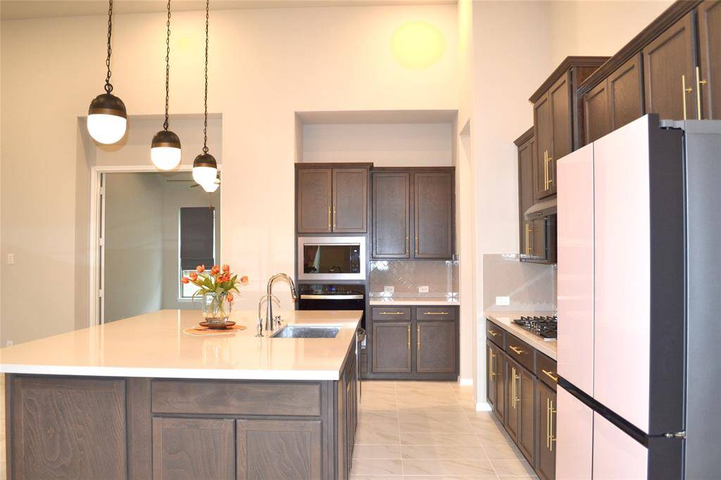 Built in wall oven and stainless steel appliances.