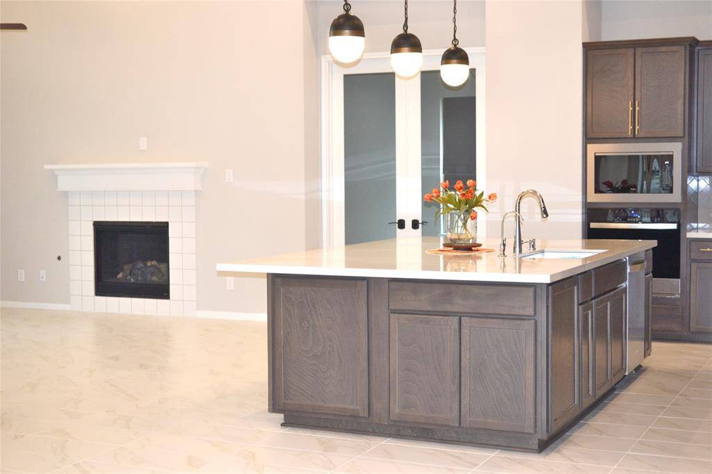 Huge Island   plenty of cabinets around the island for storage needs .White and bright bright Quatz countertops.