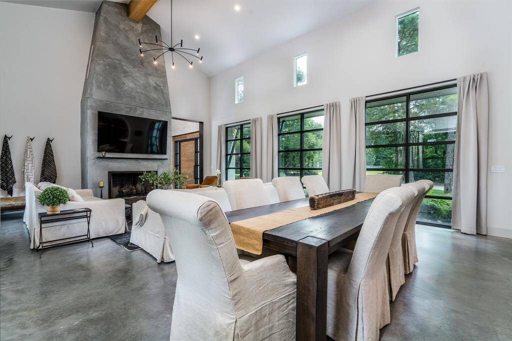 Large living area with ample natural lighting from the windows, polished Concret floors, flush mounted base boards