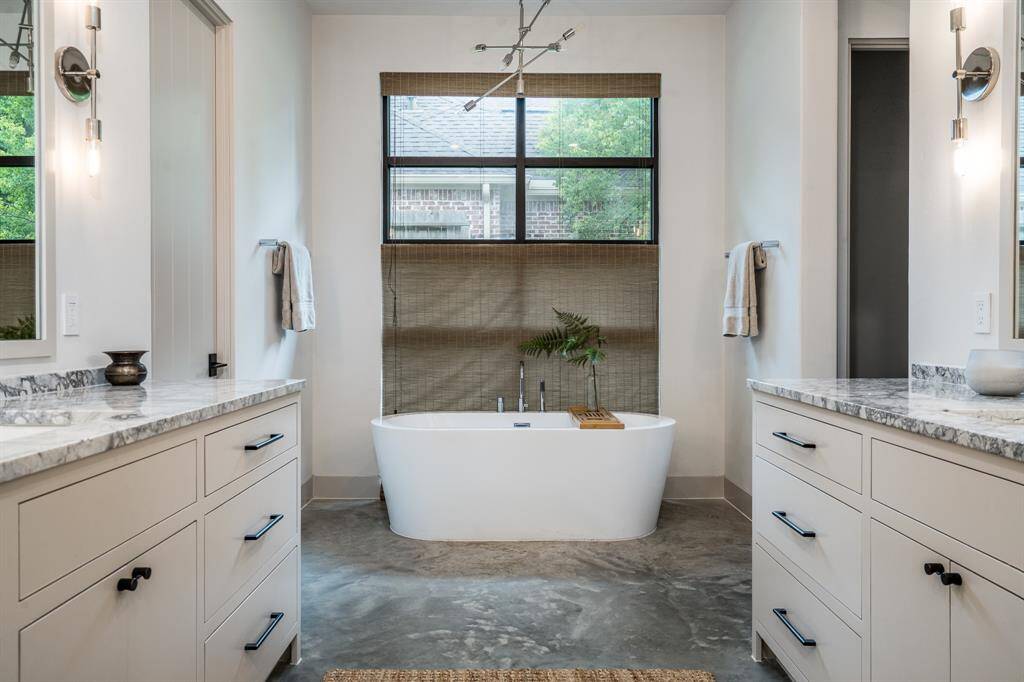 Primary Bathroom with Stand alone tub, dual walk in closets and a large walk in shower