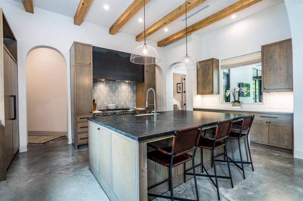 Quartz countertops, exposed beams, Sub-zero Paneled refrigerator plus more