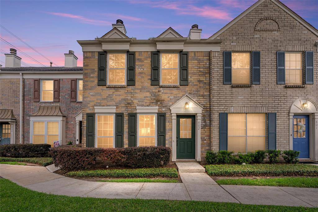 Welcome to 2810 Grants Lake Boulevard #802, a beautifully maintained townhome located in the desirable community of The Towns of Grants Lake. This charming brick residence offers classic curb appeal with its symmetrical design, shuttered windows, and manicured landscaping.