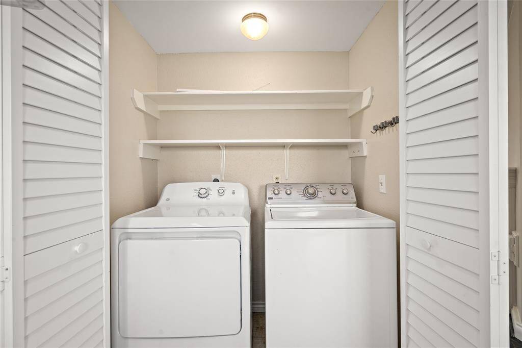 Utility closet conveniently located just off the kitchen. Behind the louvered double doors is a spacious area designed to accommodate a full-size washer and dryer, offering both functionality and easy access without disrupting the clean aesthetic of the space.