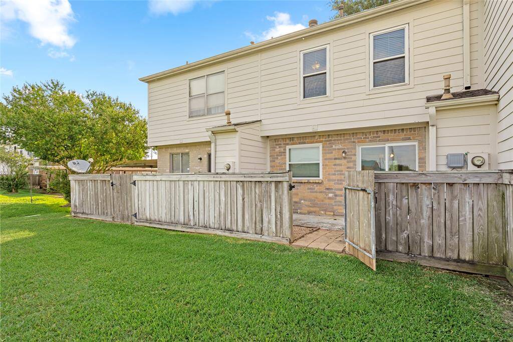 Step outside to your private fenced-in patio, perfect for morning coffee or evening relaxation. The gate opens to a lush, open green space, offering extra room to enjoy the outdoors.