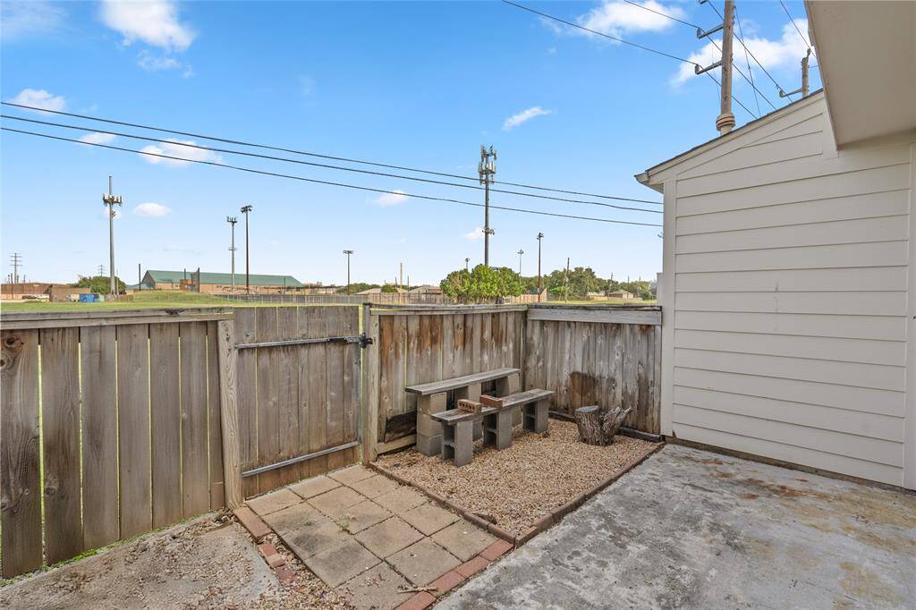 Another view of the spacious back patio reveals its true potential—add your own touch with a charming garden, cozy seating area, or even a grill setup. It’s the perfect spot for outdoor entertaining or simply unwinding after a long day. With no back neighbors, you’ll enjoy added privacy and peaceful views.