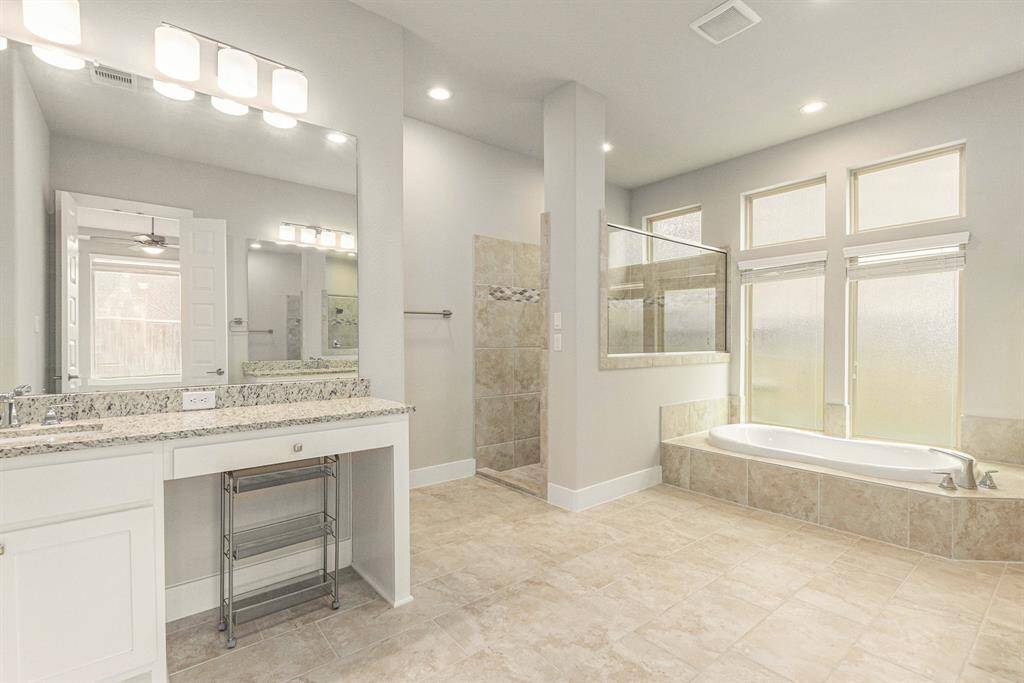 Double vanities, soaking tub, walk-in shower, and a dream closet—all the essentials of a luxury bath.