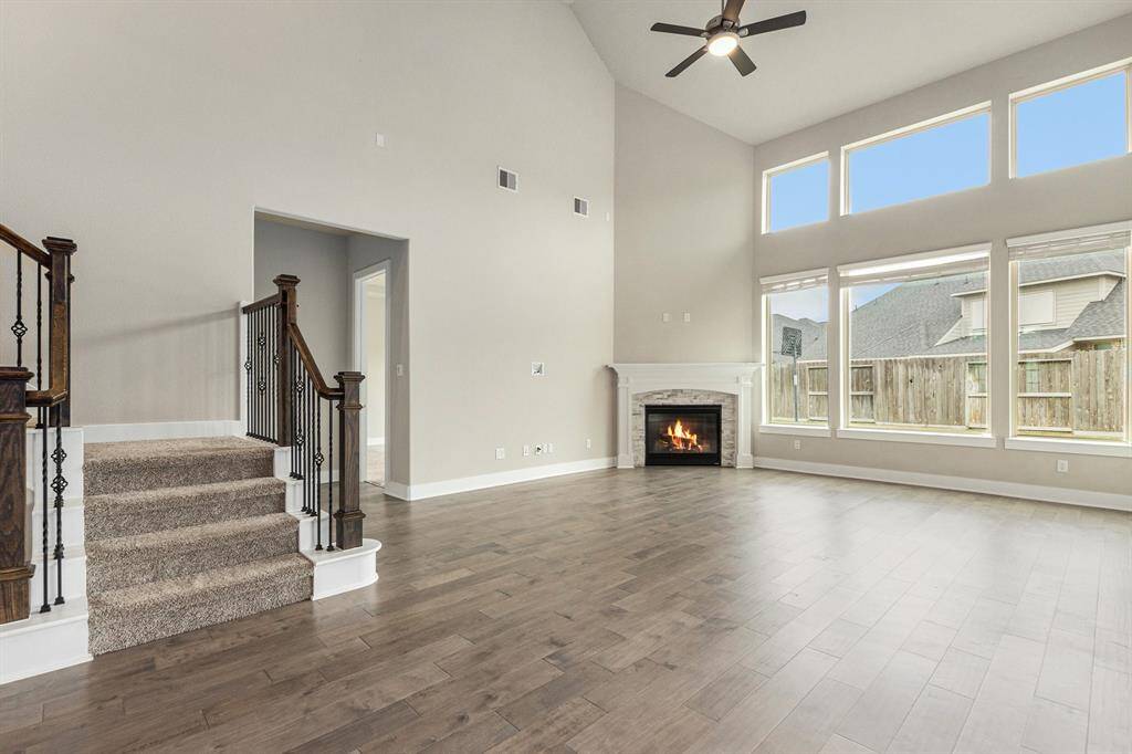 Spacious open-concept living room with wall-to-wall windows, perfect for cozy evenings or entertaining guests