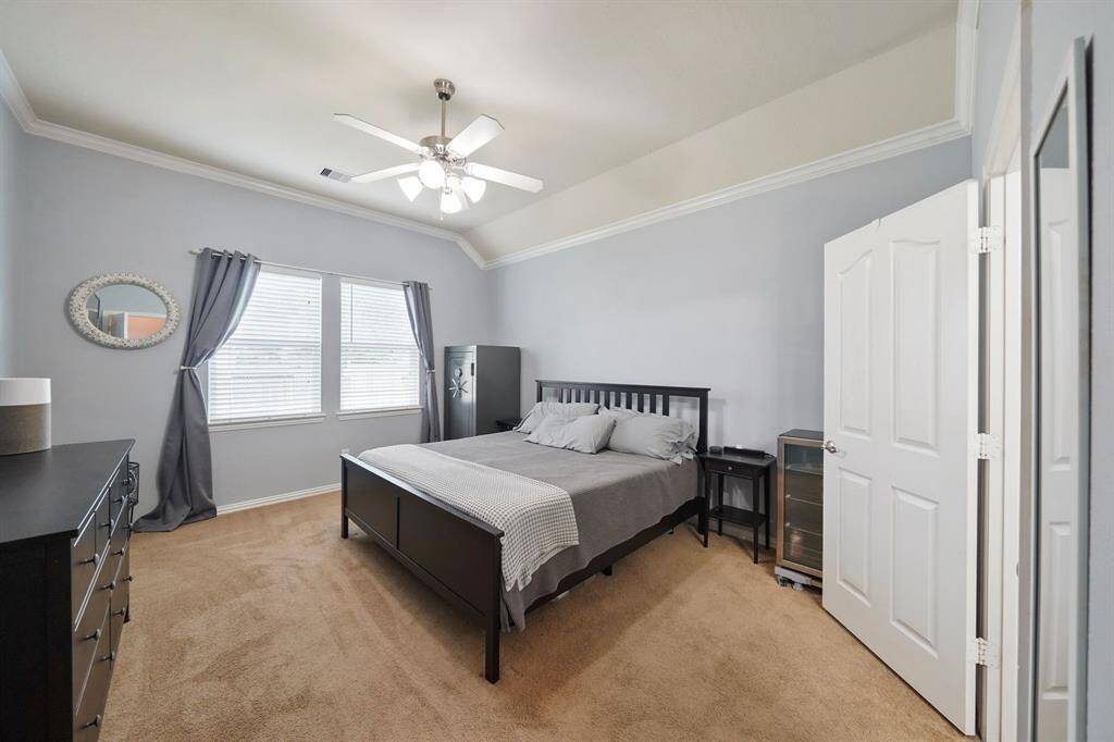 Neutral hues adorn the walls in the primary bedroom .