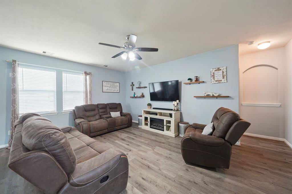 Two large windows that provide ample natural light, decorative shelving adds a personal touch.