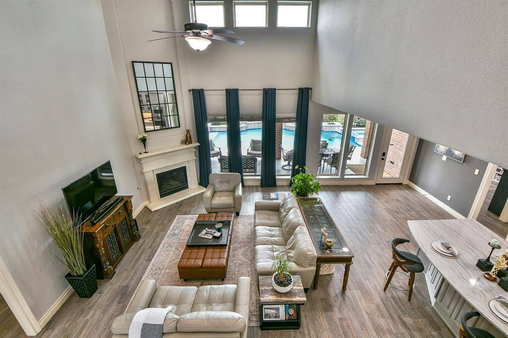 Bright and airy living room featuring natural light and stunning views of the sparkling pool, perfect for enjoying the serene outdoot ambiance.