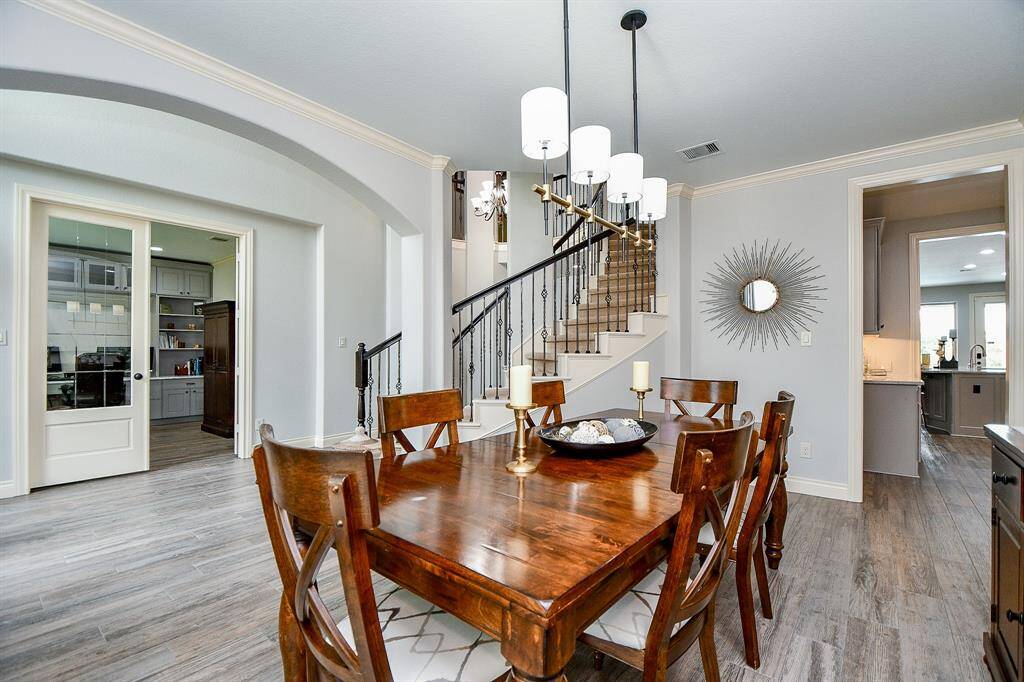 This view depicts just a short definition of the timeless beauty and versatility of the open floor plan design concept, which provides tremendous open unobstructed living space; with access to the kitchen (right) as just one example. Across the main hallway (left) is a fabulous home office/study, as desired.