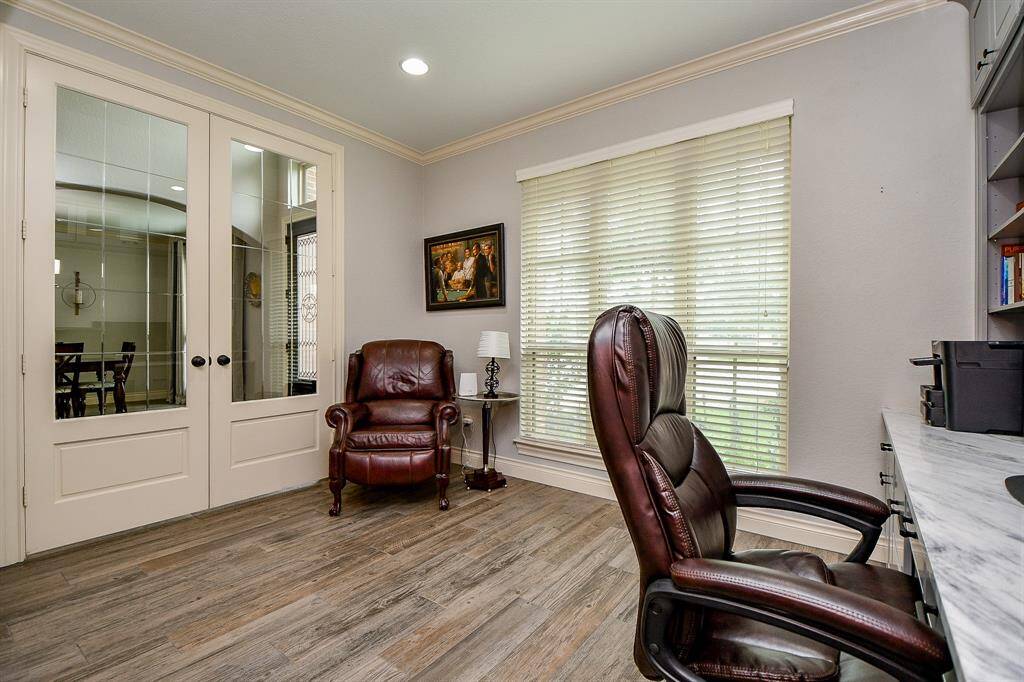 Sparkling, clear-paned french doors open on to this stately home office. Note, the updates include Quartzite counters.
