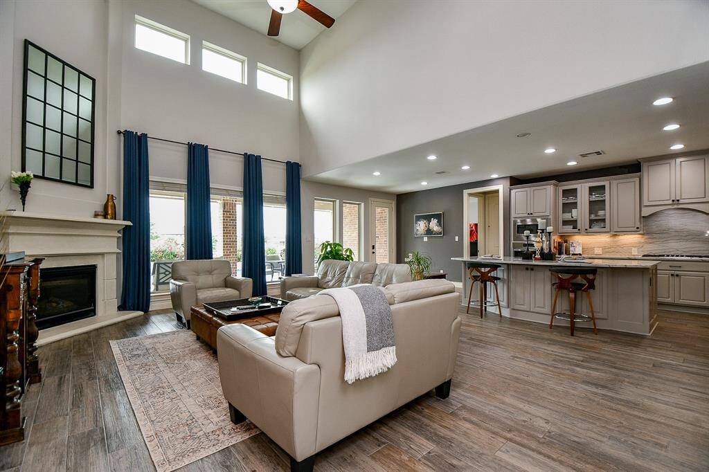 This is a one-of-a-kind living experience, with walls of windows up and down, a heavenly high vaulted ceiling, cool walls, wood look tile flooring; incredible space for placing treasured pieces and creating 'moods'; all overseen by the angled built-in fireplace, which is bound to be the star of any entertaining show you host! And, the special chef's kitchen that shares this space'