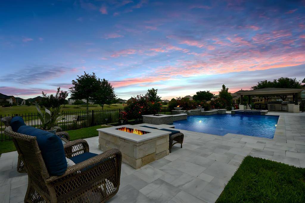 This view from the fire pit gives you idea of how long the pool is and the pavilion on the other side!