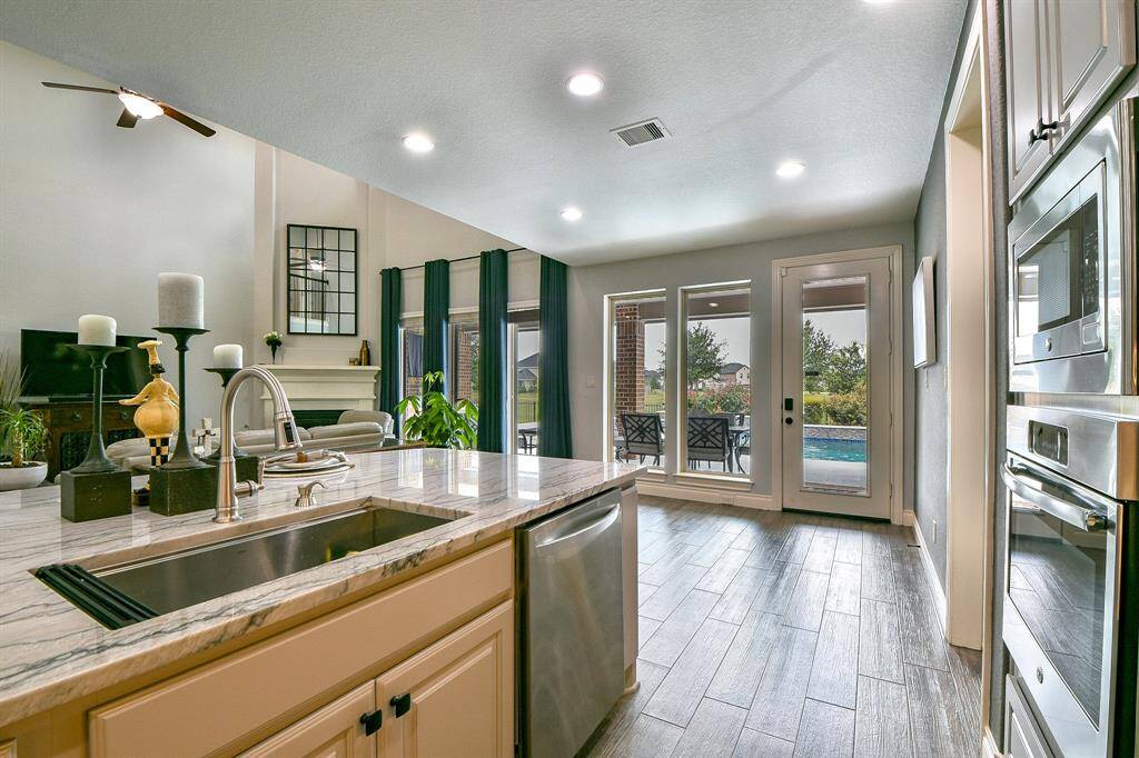 Fantastic view from the kitchen shows off the wood look low maintenance tile and that gorgeous Quartzite counters.