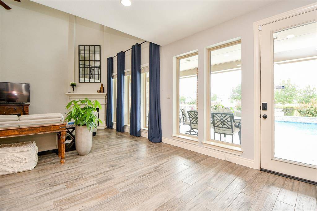 The beauty of this home is being able to see the backyard oasis (and beyond) from the family and kitchen areas.  Covered outdoor dining is conveniently located near the kitchen for entertaining.