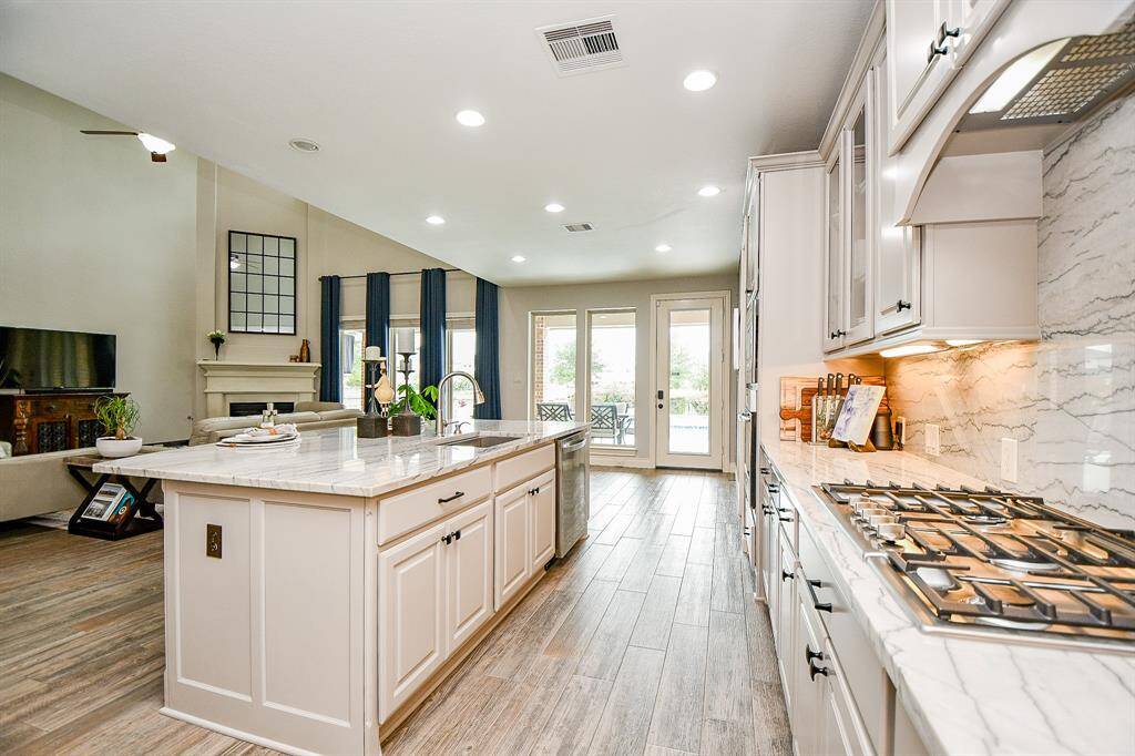 The kitchen has Quartzite counters and backsplash that give a sleek look to this space. Counter height breakfast bar or for entertaining.