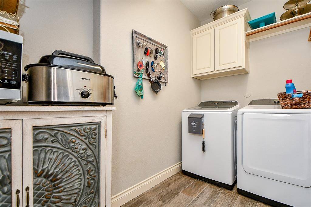 Even the spacious utility room hosts laundry appliances and also serves as a catch-all space for housekeeping materials.