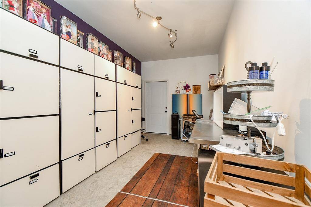 This 3rd tandem bay has been finished out as a hobby room. With a door to the garage and another door opens to the bathroom and secondary bedroom on first floor.