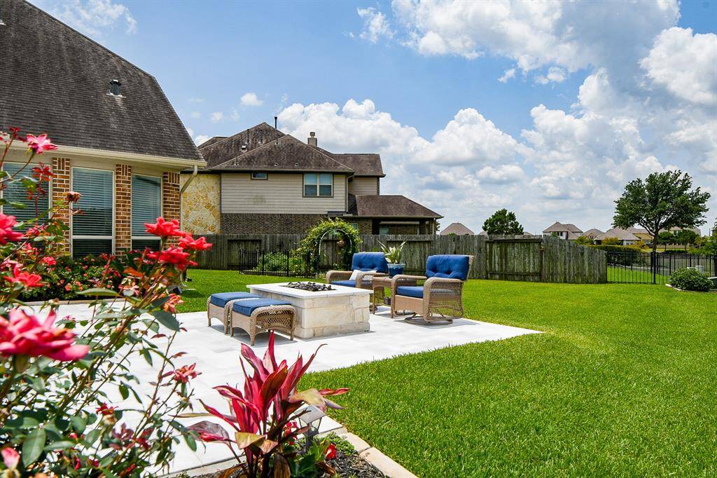Cozy outdoor sitting area centered around a built-in gas firepit—perfect for relaxing evenings under the stars. This inviting space offers the ideal setting for entertaining or quiet nights by the fire and pool.