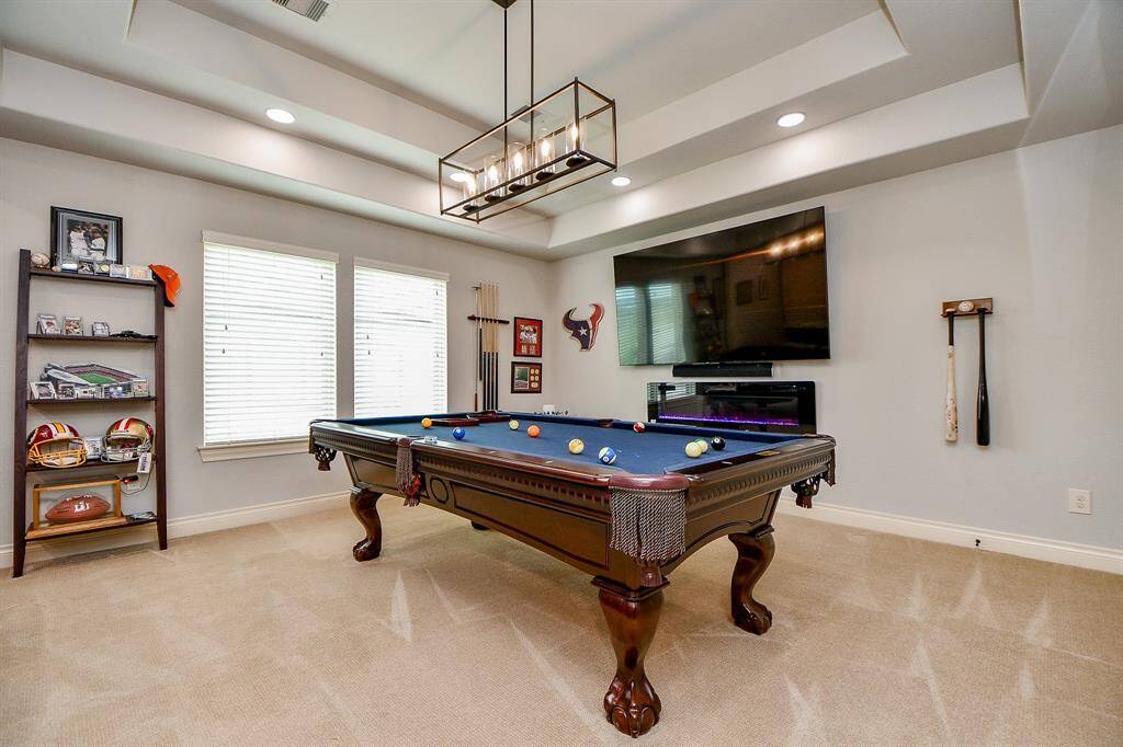 Game room space has electric fireplace and Phillips Hues lighting system.