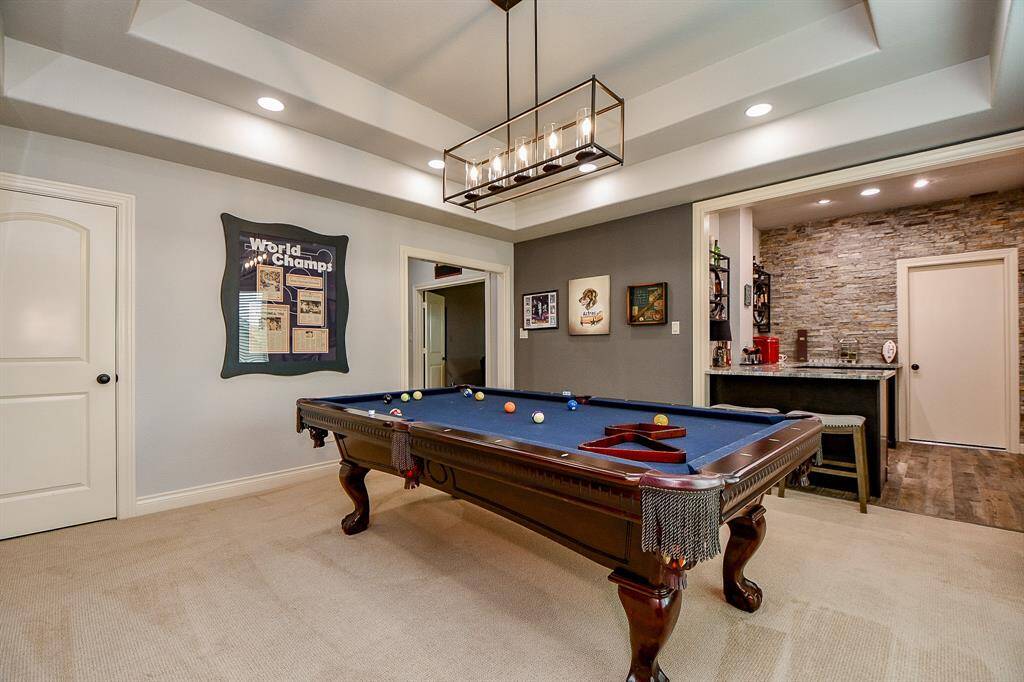 Great view of the game room and custom bar. The doorway leads to a Texas Basement!