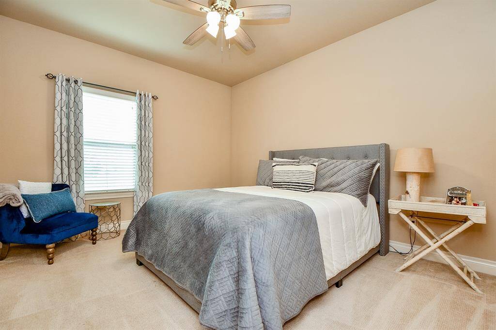A generous carpeted secondary bedroom easily welcomes good-sized pieces.