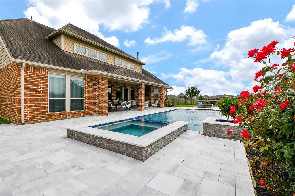 At any time of day or night, this private retreat is available for relaxing indulgence just footsteps from your gracious patio and separate outdoor kitchen and bar area covered with 1,600 square-feet of gorgeous white Travertine tile!