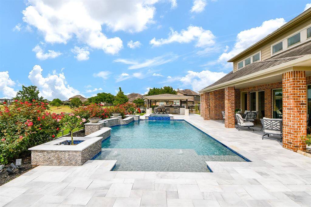 Beautiful fire bowls are perfect setting for this grand pool/spa setting. This view is from the FIRE PIT.